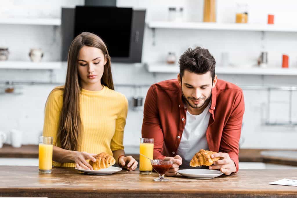 Couple Eating Bread Woman Unhappy