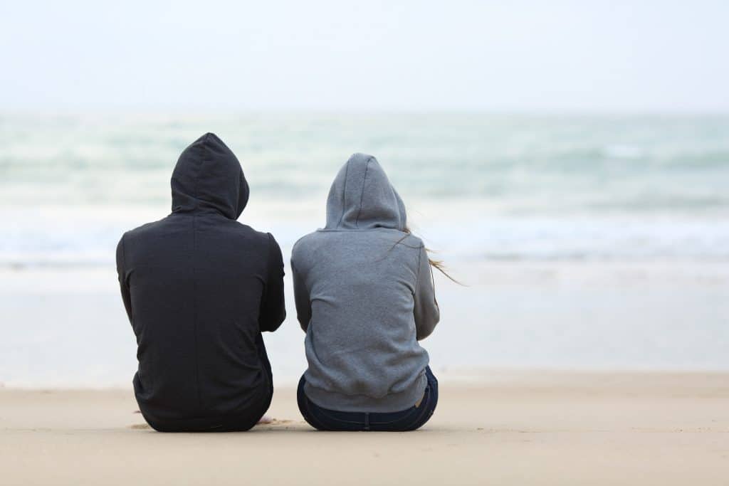 Couple Sitting On The Beach