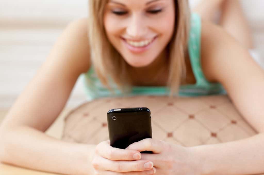 Woman Laying Down And Texting