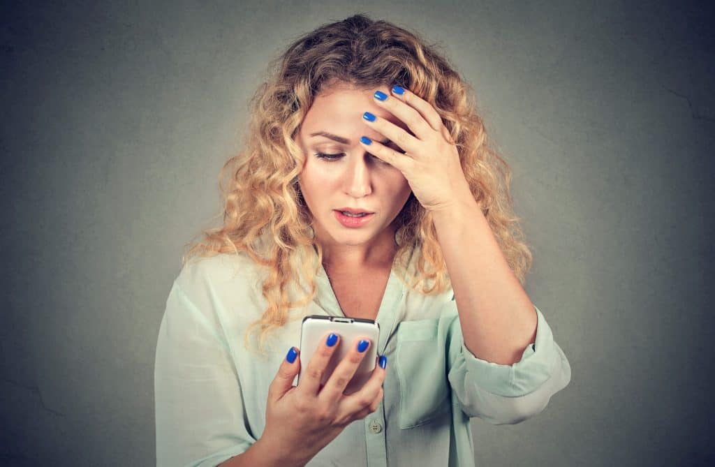 Woman Worried Holding Her Phone