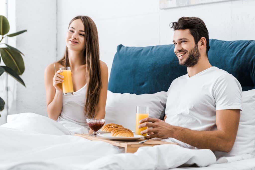 Couple In Bed Having Breakfast