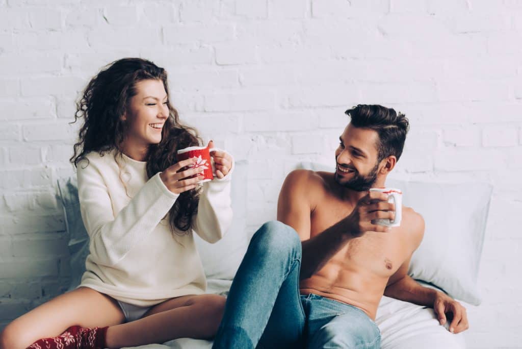 Couple Laughing And Drinking Coffee