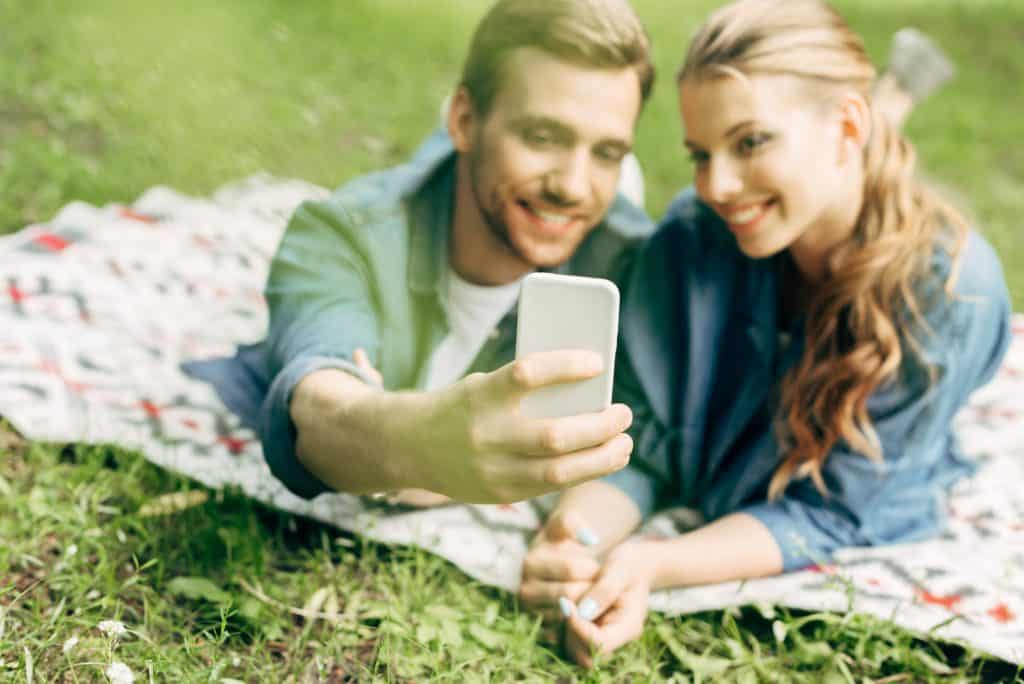 Couple On A Picnic Taking A Selfie
