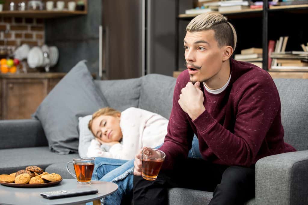 Man Having Tea Girlfriend Sleeping